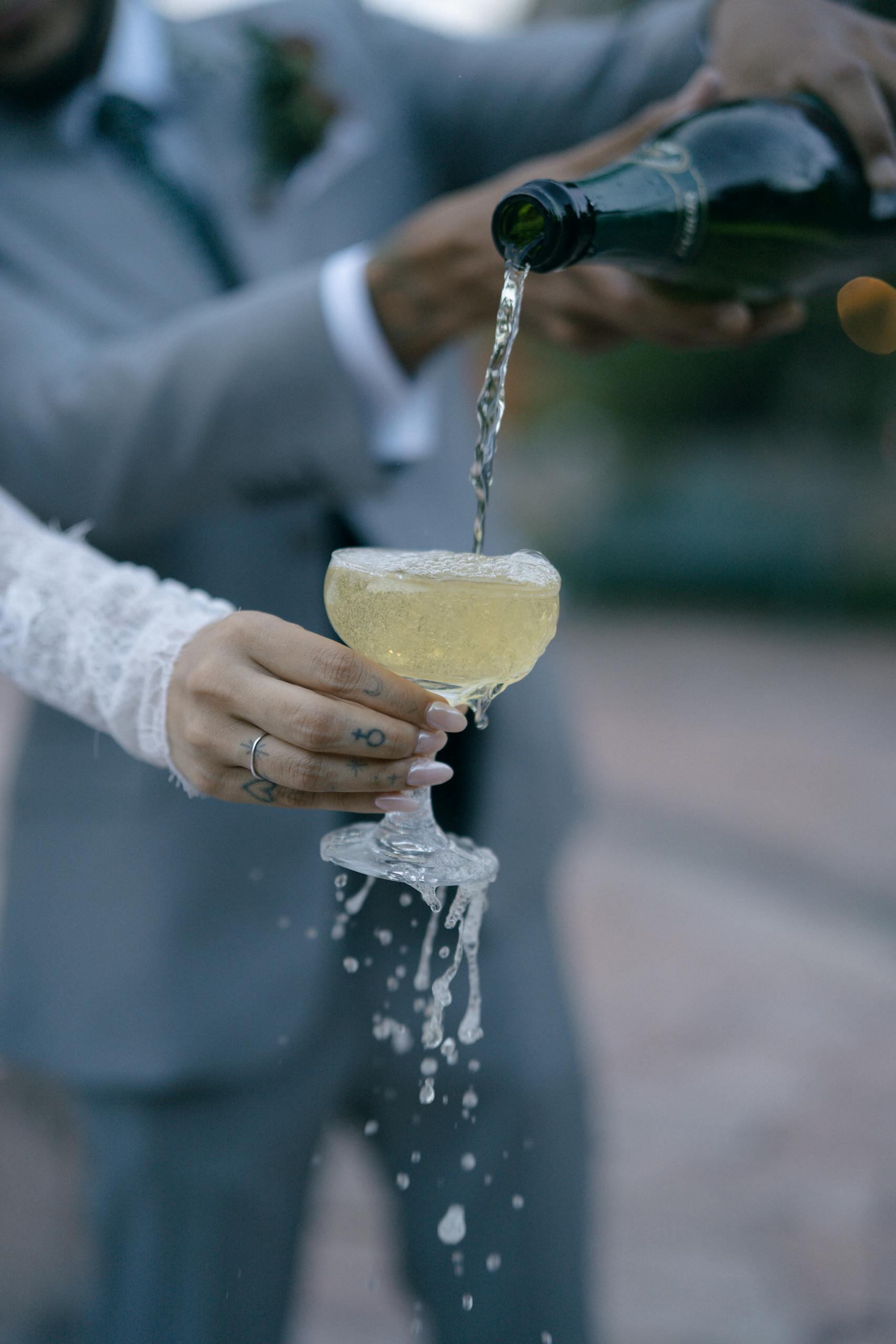 Bride and groom celebrate with champagne at El Castillo, Querétaro, México.