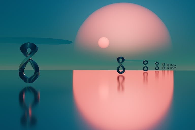 Surreal abstract scene with metal loops reflecting on water at sunset.