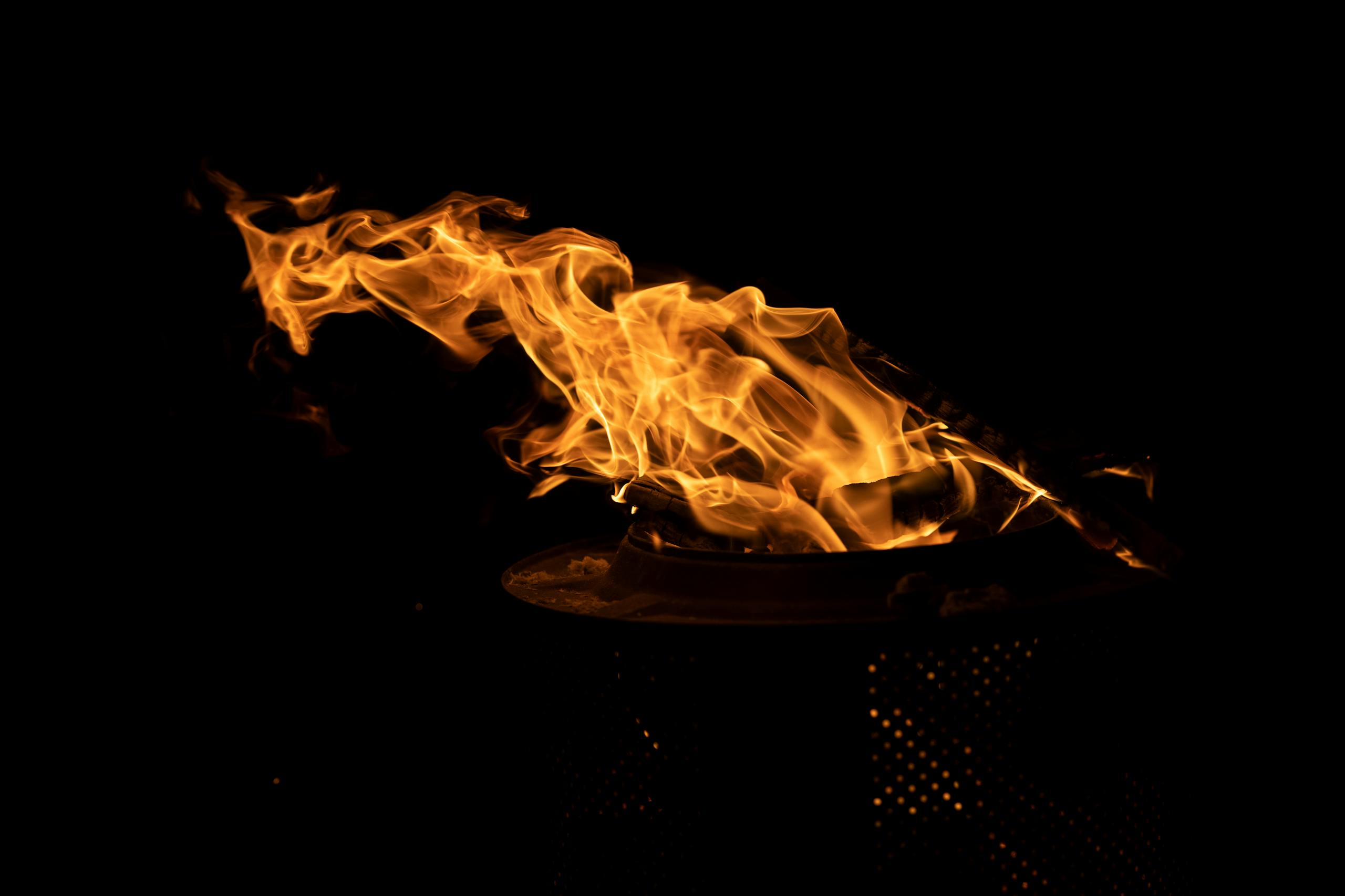 Vibrant flames flicker against a dark backdrop, creating a captivating visual of light and heat.